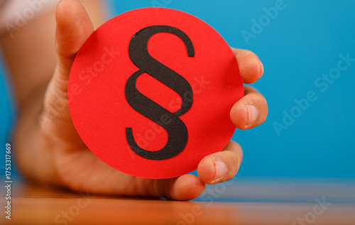 A hand holds a red circle w...