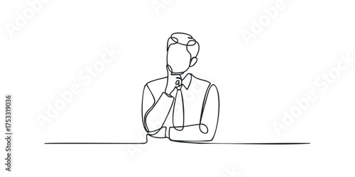 Man in suit contemplating with hand on chin