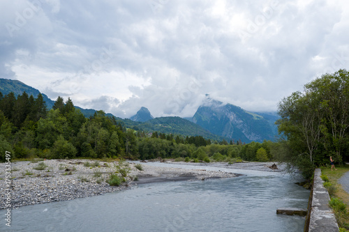 Fototapeta Naklejka Na Ścianę i Meble -  This landscape photo was taken in Europe, France, Auvergne-Rhone-Alpes, Haute-Savoie, Morillon, in summer. It shows the Giffre River bank in Morillon, under the Sun.