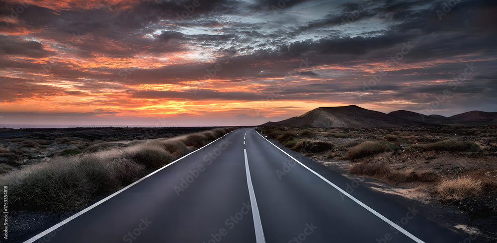 Fototapeta premium The Golden hour in summer.to unexplored road journeys and adventures. Road through the scenic Sunset landscape to the destination in natural park Amazing panorama.
