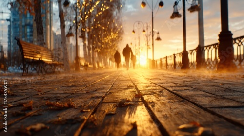 A serene view of silhouettes walking along a misty boulevard at sunset, capturing the beauty of nature and human connection in an enchanting glow.