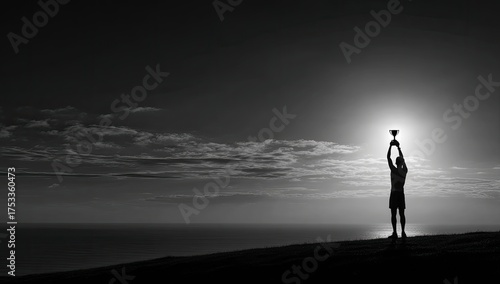 Silhouette of a person holding up a trophy with the ocean and sun in the background