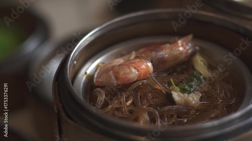 A close-up shot of various dim sum dishes served in traditional bamboo steamers at Dim Sum restaurant. Cinematic lighting. Delicious dim sum, Chinese food.