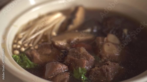 Bak-kut-teh is a pork rib dish.Dim Sum is traditional chinese food, people traditionally enjoy in restaurants for breakfast and lunch. Close up of Steamed Dim Sum in bamboo dish at chinese restaurants