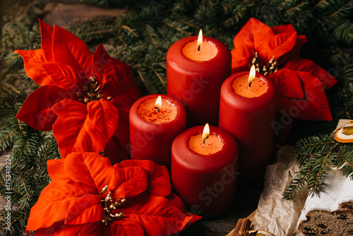 four burning Red advent candles in advent wreath decoration on wooden dark background. tradition in time before Christmas. xmas lights with christmas fir deco background concept. Festive still life.