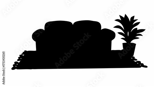 Silhouette of a couch with cushions and a potted plant next to it on a rug in a room interior design
