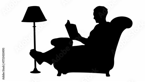 Silhouette of a person reading a book while sitting in a chair next to a floor lamp in a dark room