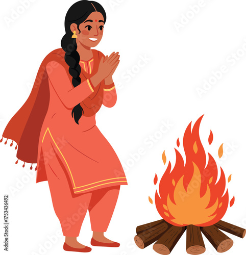 A smiling Indian woman in traditional attire praying by a bonfire during a festival.