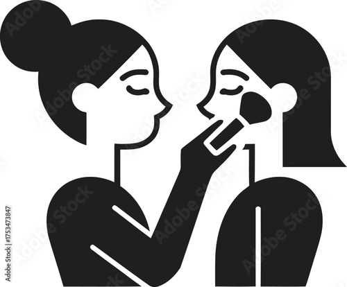 Makeup artist applying blush to a woman s cheek with a brush