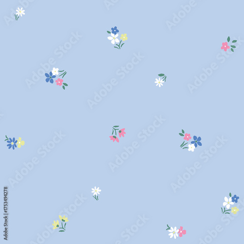 Minimalist ditsy floral seamless pattern. Simple small wildflower bouquets on a light blue background. Cute and delicate botanical print for spring fabric, wallpaper, or textile design.