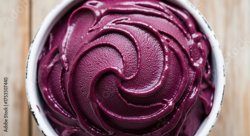 Closeup of a bowl of vibrant purple acai sorbet with swirling texture