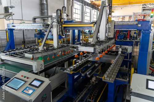 A modern automated stamping machine on a refrigerator production line