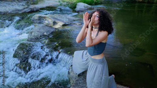 A Serene Moment by the Water: Captivating Transformation of a Young Woman in Nature, Exploring Beauty and Emotions Amidst Flowing Streams and Natural Surroundings