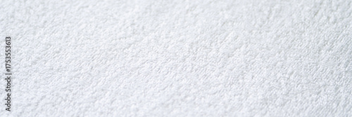 Close-up of white textured terry cloth fabric with soft and absorbent material surface.