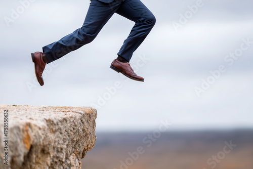 Close up, A businessman leaping from one cliff to another, concept of risk