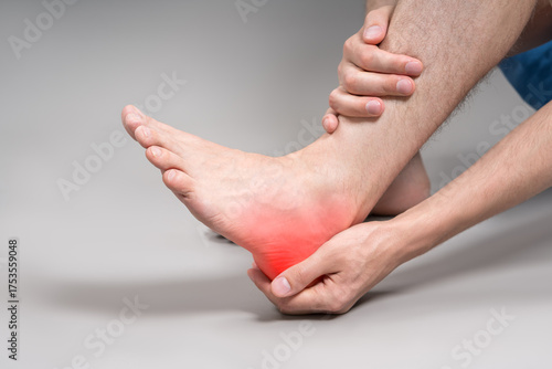 Foot pain, corns and calluses, dry skin on legs, man suffering from feet ache, podiatry concept