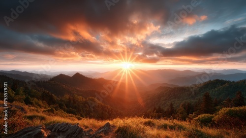 A stunning sunset view over a mountain landscape, captured in dramatic light with vibrant colors radiating across the sky and illuminating the serene hills below.