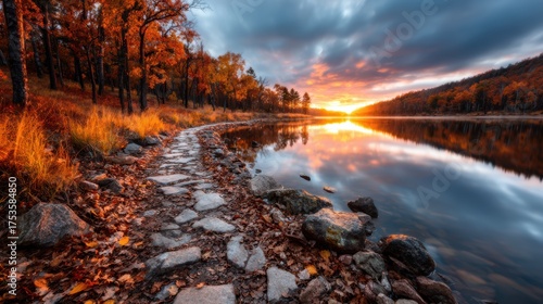 An enchanting view of autumn foliage reflecting on a calm lake, with a stone pathway leading into the picturesque scenery, inviting contemplation and appreciation of nature's changes.