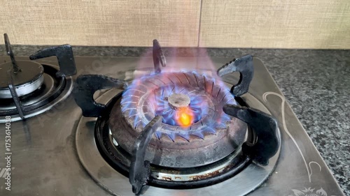 Video of a gas stove burner turning on, Ideal footage for themes related to energy use, household appliances, cooking, safety, and natural gas.