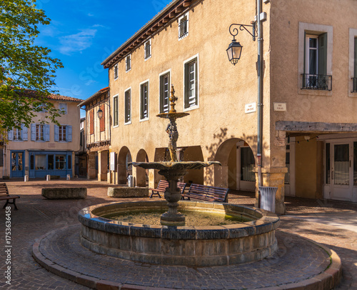 фотографія A small square and fountain in the town of Sorèze, with the clock tower, in Occi