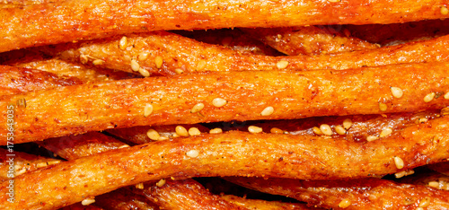 Chinese spicy soy meat.Chinese snacks for beer.Soy sticks with sesame seeds.Asian spicy sausages.Soy snacks background.