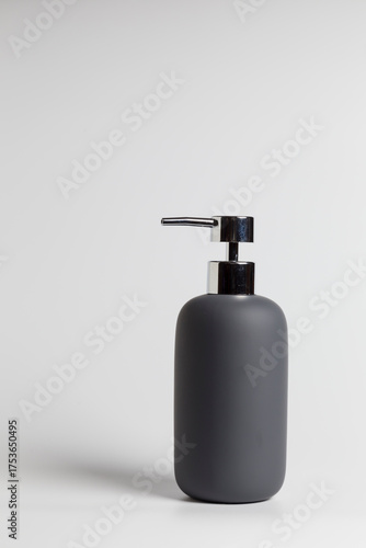 black soap dispenser bottle, placed on a white background