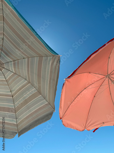 Sky view with two colorful umbrellas on the beach