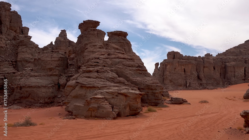 Fototapeta premium A trip to Sahara desert in Algeria. Beautiful african travel photo. Sandy landscapes, mountains, rocks, dunes, and nature. Summer vacation in arab country.