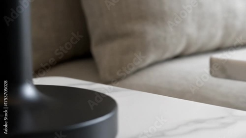 Minimalist Black Table Lamp on a White Marble Nightstand.