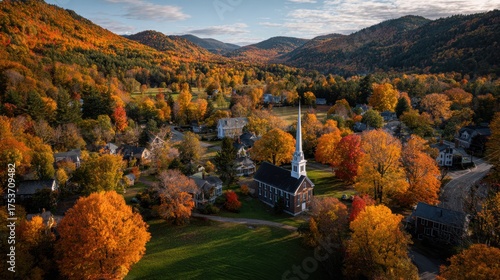Aerial view of autumn foliage and church in new england village landscape
