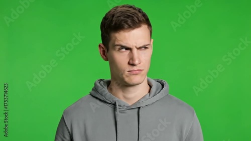 Young Caucasian Man Expressing Anger and Disapproval on Green Screen.