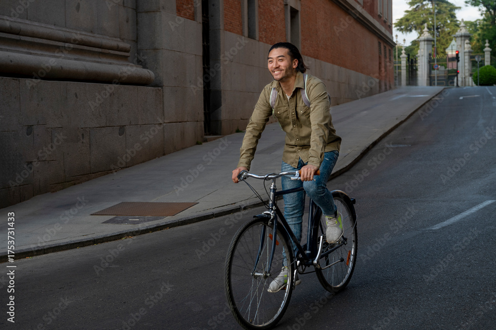 Fototapeta premium Young asian man biking in urban street
