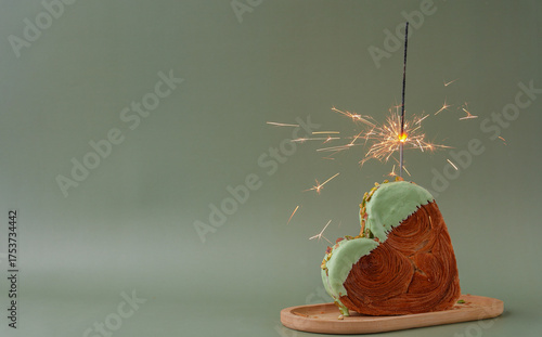 Shiny festive candle sparkler birthday celebration holiday Delightful and vibrant heartshaped pastry croissant treat, beautifully topped with colorful frosting nut galore. Mock up template copy space