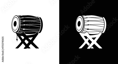 A black and white graphic icon of a traditional Indian Dholak, a two-headed hand drum, on a stand.