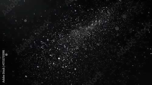 Abstract image features a dark background sprinkled with many small, luminous particles