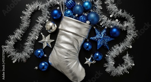 silver christmas stocking filled with blue ornaments on a black background