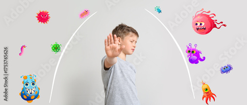 Little boy showing stop gesture on light background