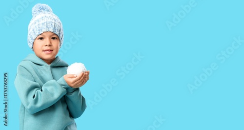 Little Asian boy in knitted...