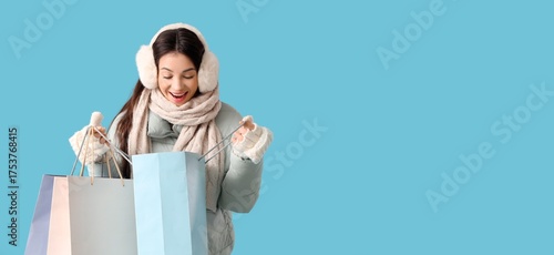 Excited young woman in warm...