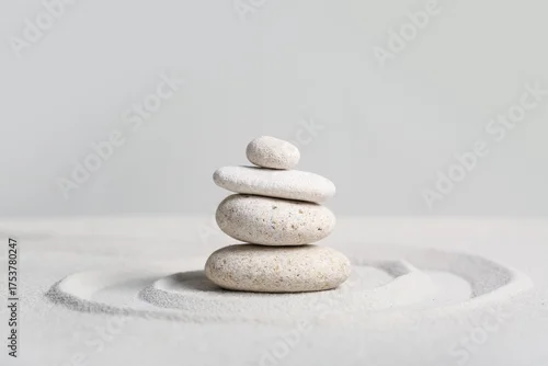 Panel kuchenny z motywem Stack of spa stones on light sand against grey wall. Zen concept