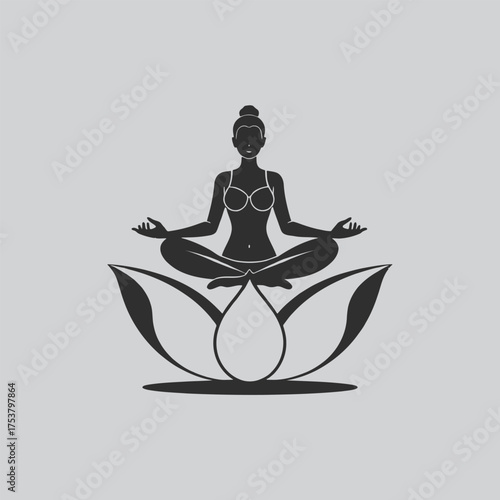 Silhouette of a woman meditating in the lotus position on a flower