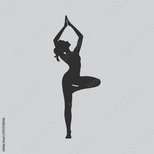 Silhouette of a woman performing the tree pose in yoga exercise