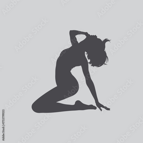 A silhouetted woman kneeling with her head bowed in a graceful pose