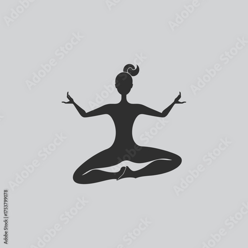 Silhouette of a woman peacefully meditating in a lotus position