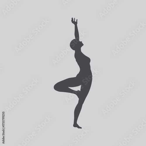 Silhouette of a woman performing a yoga pose against a gray background