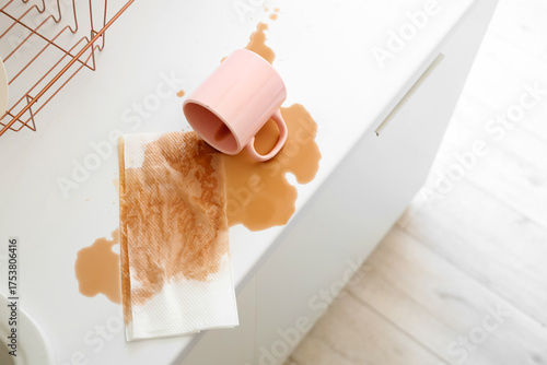 Cup with spilled coffee and...