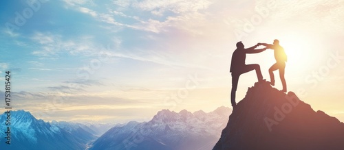 Silhouette of two men assisting each other to climb a mountain peak symbolizing teamwork and success