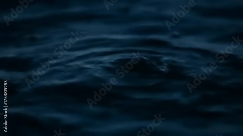 Dark Blue Water Surface Ripples Abstract Background.
