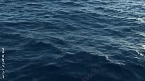 Deep blue ocean water surface with gentle ripples and reflections, creating a serene and calming natural background texture.