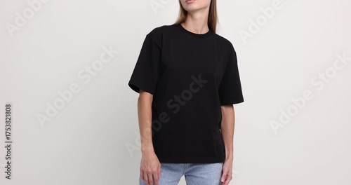 Woman wearing black t-shirt on white background, closeup. Mockup for design